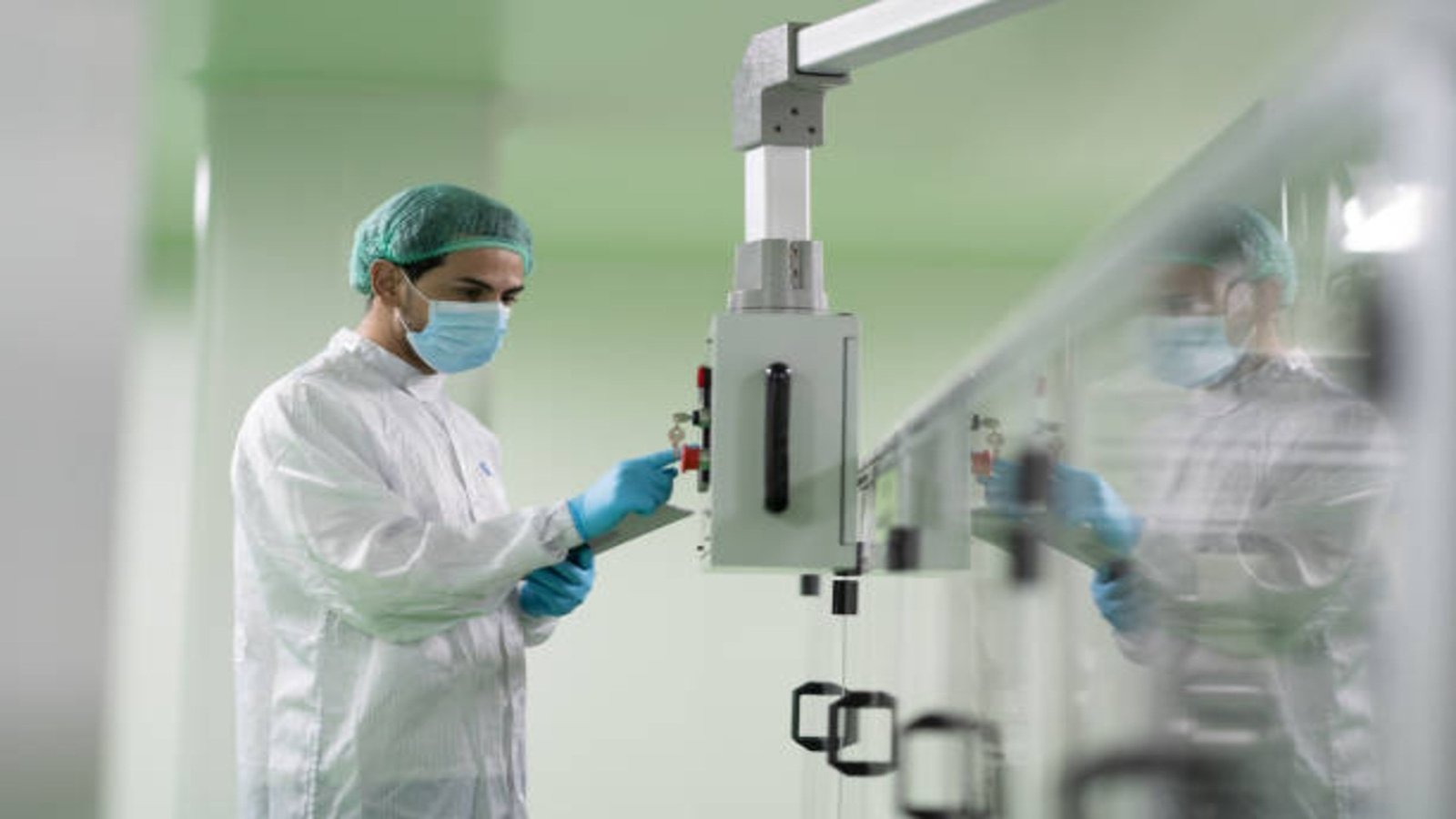 Laboratory technician examining of conveyor belt machine work in cleanroom, Laboratory Cleanroom Technician, Cleanroom manufacturing